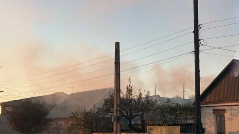 Fire in a private house thick smoke rises above the roofs in the bright spring Stock Footage 159235482