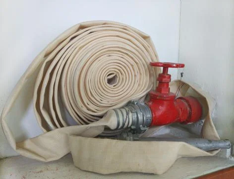 Fire protection cabinet with fire hydrant and hose. It's in the store Stock Photos
