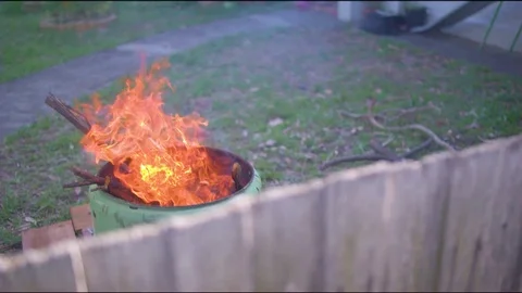 Fire put sets ablaze in the garden Stock Footage 76198759