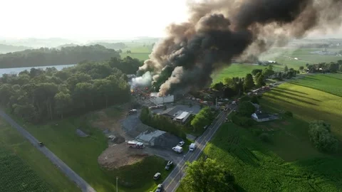 Fire rages as huge smoke pillar fills the sky, dramatic aerial wide shot, Stock Footage 246058069