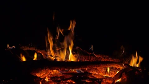 Fire on red-hot coals at night. 4K ultra hd video footage Stock Footage 98143053