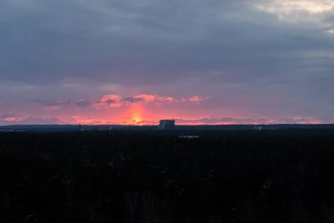 Fire red sunset over the treetops Stock Photos