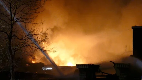 Fire ripping at night in undisclosed unknown location with water jets Stock Footage 129987450