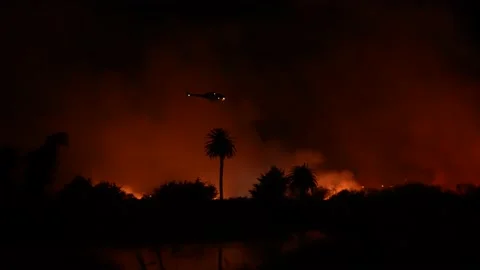 Fire at the river bottom in Ventura, CA after Santa Ana winds Stock Footage 144899907