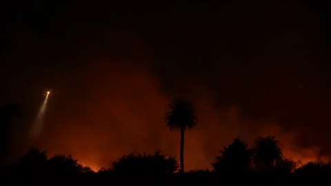 Fire at the river bottom in Ventura, CA after Santa Ana winds Stock Footage 144900506