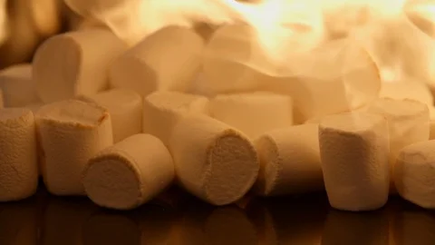 Fire roast marshmallows. Marshmallow on fire flames, slow motion shot on black Video stock 125428628