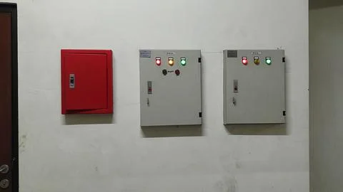 Fire Safety and Electrical Control Panels on White Wall Stock Photos