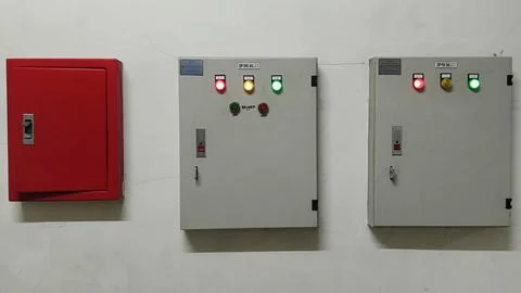 Fire Safety and Electrical Control Panels on White Wall Stock Photos