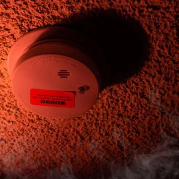 Fire safety button on orange background and smoke. Fire safety, fire warning, Stock Photos
