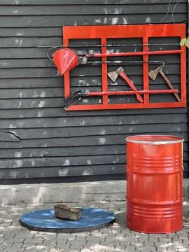 Fire safety corner under the open sky: axe, bucket, shovels, barrel of sand Stock Photos