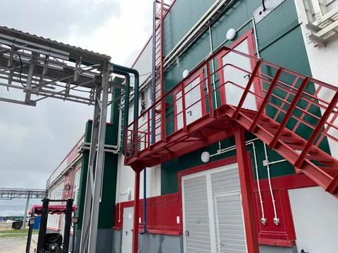Fire safety elements on the wall of an industrial building: stairs, fences, s Stock Photos