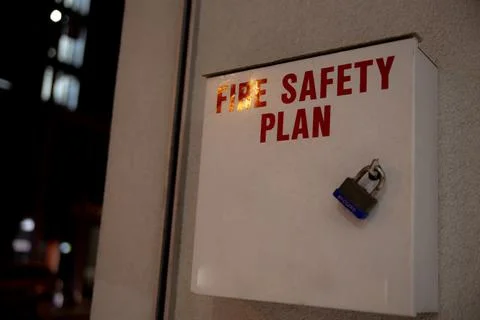 Fire safety plan box next to fire alarm monitor facing streets outside building. Stock Photos