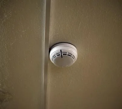 A fire sensor on the ceiling. Fire protection system in the form of a white b 写真素材