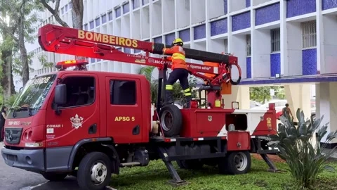 Fire Service Boom Truck Deployed, Crew Operates Lift Beside Apartment Block Stock Footage 330855926