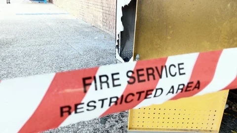 Fire Service Restricted Area tape cordons off suspected exploded bin, Stockbeeldmateriaal 115264136
