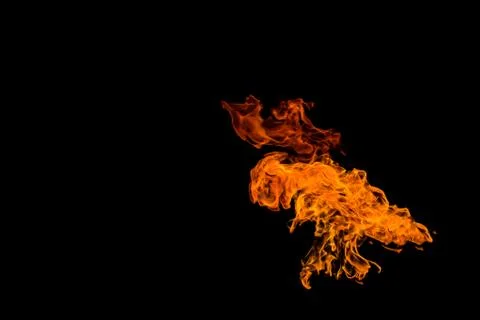 Fire in the shape of an alien UFO with wings. The flame on the black backgrou Stock Photos
