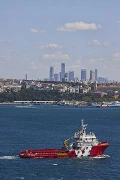 A fire ship sails against the background of the city of Istanbul Stock Photos