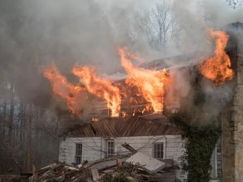 Fire shooting from windows during house fire Stock Photos