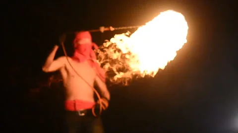 Fire show artist juggling fire in the dark Stock Footage