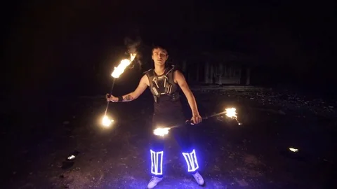 Fire show, dancing with flame, a man in a suit LED dances with fire, draws a 스톡 동영상 82291299