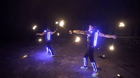 Fire show, dancing with flame, a man in a suit LED dances with fire, draws a Stock Footage 82291429