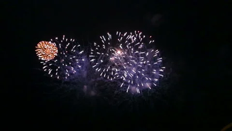 Fire show festive fireworks in the night sky above the river reflecting in the Stock Footage 115097989