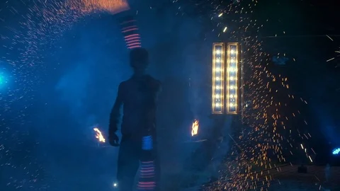 Fire Show. Guy Twists In His Hands Stick From Which Many Sparks Of Fire Go Out Stock Footage 110331023