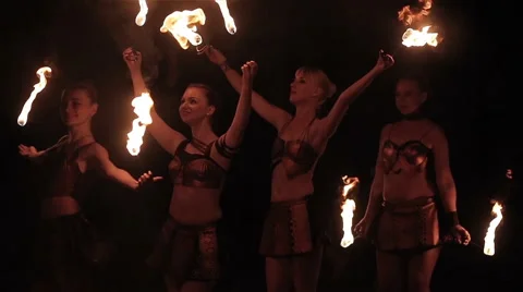 Fire show performance. Female fire performers dance with burning fire torches Stock Footage 62495806