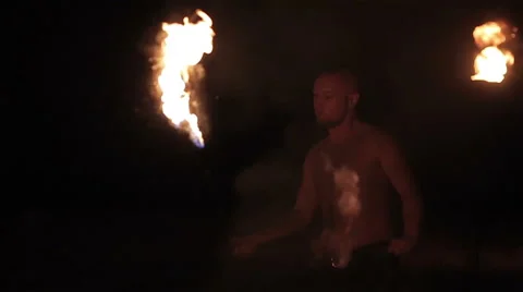 Fire show performance. Male fire performer spinning burning fire rope dart poi Stock Footage 62495900
