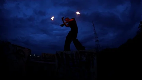 Fire Show Performance at night with glimmer city lights on blur background 스톡 동영상 114157358