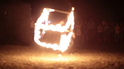 Fire show performer spinning a fire cube at night. Video stock 77233344