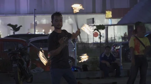 Fire show of street performer juggling fire torches on main street Stock Footage 107076384