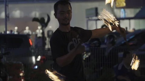 Fire show of street performer juggling fire torches on main street Stock Footage 107076386