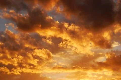 Fire sky background. Soft clouds with the hint of the sun at sunset. Stock Photos