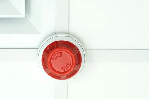 Fire smoke detector with dust cap fitted. Stock Photos