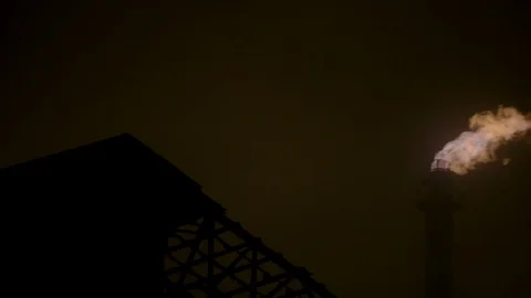 Fire smoke stack factory at night zoom out to wide shot Stock Footage 89945372