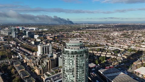 Fire smoke visible over Hounslow, London aerial view Stock Footage 323681072