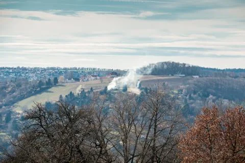 A fire somewhere on the field or in the forest near the village Stock Photos
