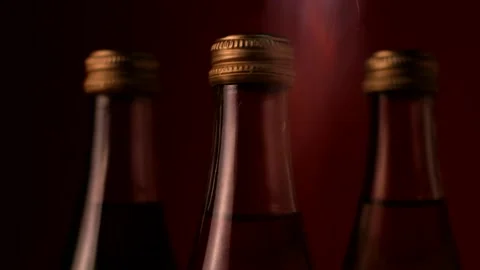 The fire sparkles over the bottles. The flame goes on the lids 스톡 동영상 150683378