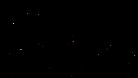 Fire sparks dust flying slowly rising up background. Video stock 336859608