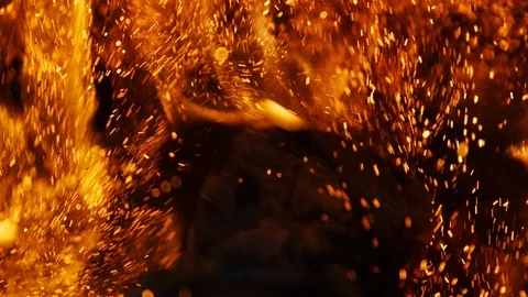 Fire sparks moving on dark at black background coming from brightly burning warm Stock Footage 89800224