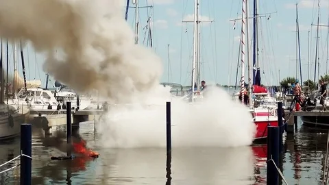 Fire on speedboat in harbour 4 Stock Footage 79847478