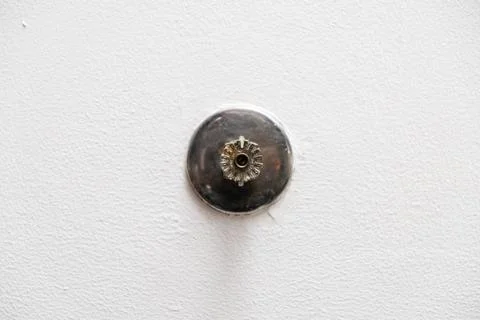 Fire sprinkle head mounted on a clean white ceiling Stock Photos