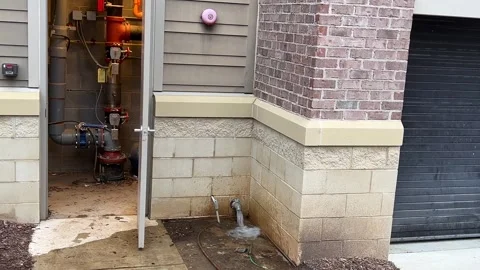 Fire sprinkler riser room with water rushing out of a pipe Stock Footage 301228820