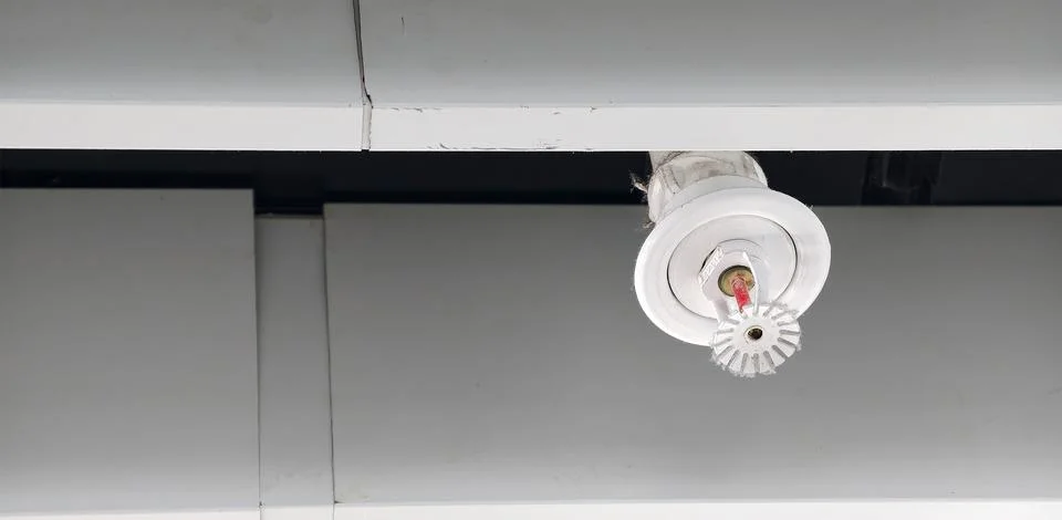 Fire sprinkler system installed on ceiling in a commercial building Stock Photos