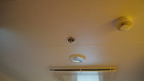 The fire sprinklers on the ceiling of the room inside Stock Footage 97675816