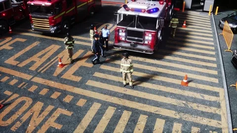 Fire station. A firefighter stands next to a fire engine. Stock Footage 333418684