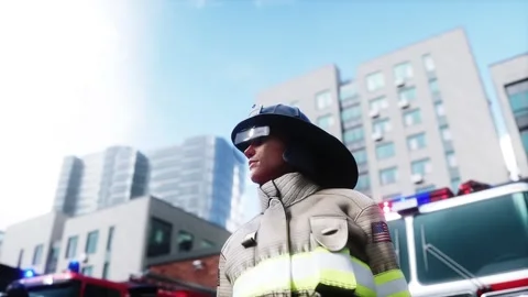 Fire station. A firefighter stands next to a fire engine. Stock Footage 333418712