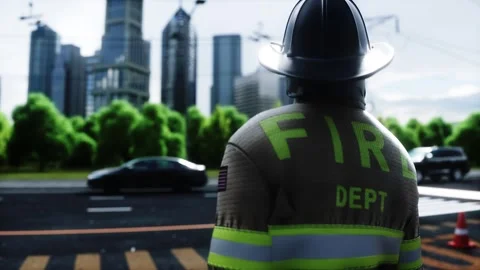 Fire station. A firefighter stands next to a fire engine. 動画素材 333418719