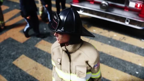 Fire station. A firefighter stands next to a fire engine. Video stock 333418723